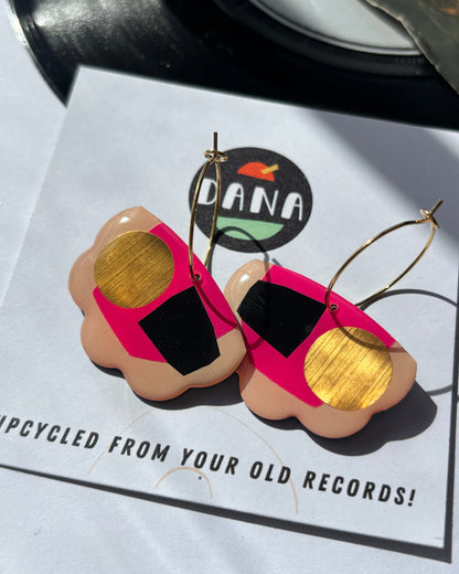 Upcycled record earrings on a card with 'DANA' branding and text about upcycling from old records.