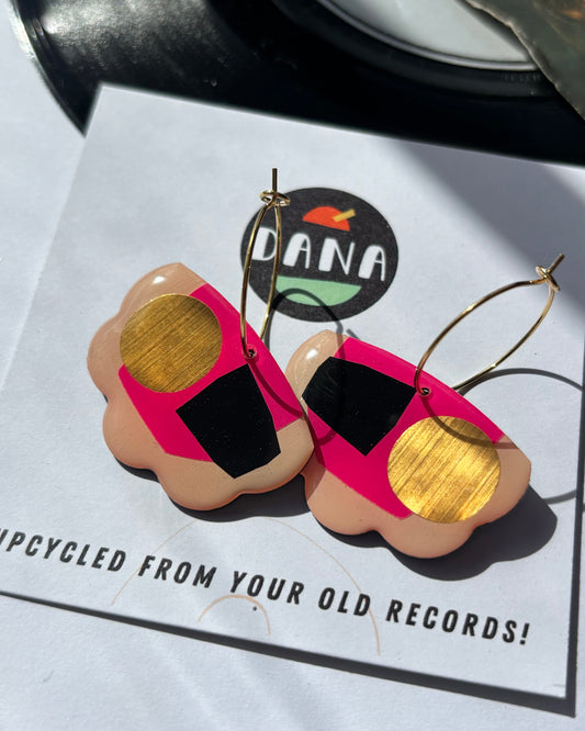 Upcycled record earrings on a card with 'DANA' branding and text about upcycling from old records.