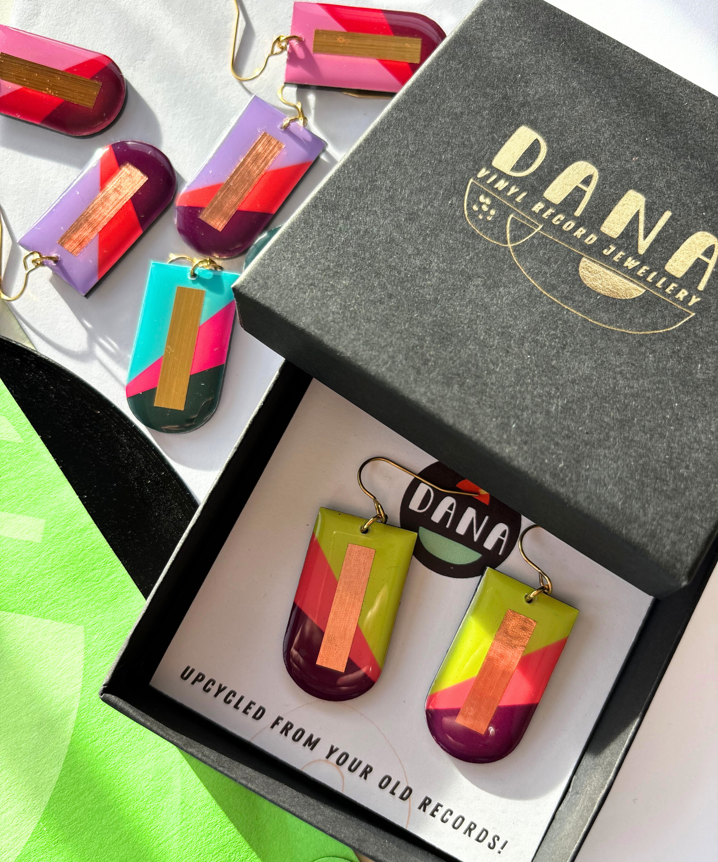 NINA in lime green, deep orange, plum, and copper