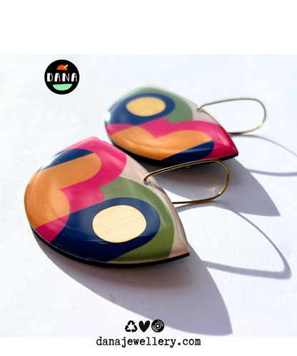A pair of colourful statement funky art earrings handmade in Ireland by DANA Jewellery featuring geometric patterns in blue, pink, green, yellow, gold.