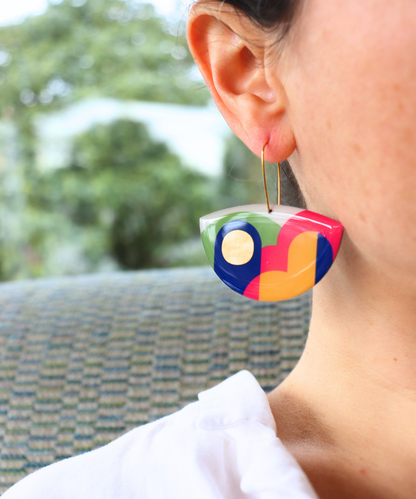 A pair of colourful statement funky art earrings handmade in Ireland by DANA Jewellery featuring geometric patterns in blue, pink, green, yellow, gold.